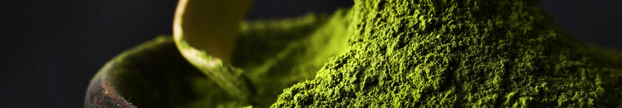 Matcha green tea powder Matcha green tea powder hill in a bowl with spoon close up view